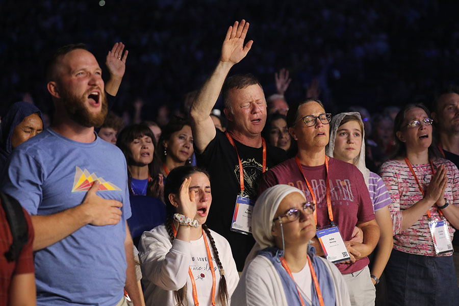 Pilgrims pray during Eucharistic adoration at the opening revival night July 17, 2024, of the National Eucharistic Congress at Lucas Oil Stadium in Indianapolis. (OSV News photo/Bob Roller)
